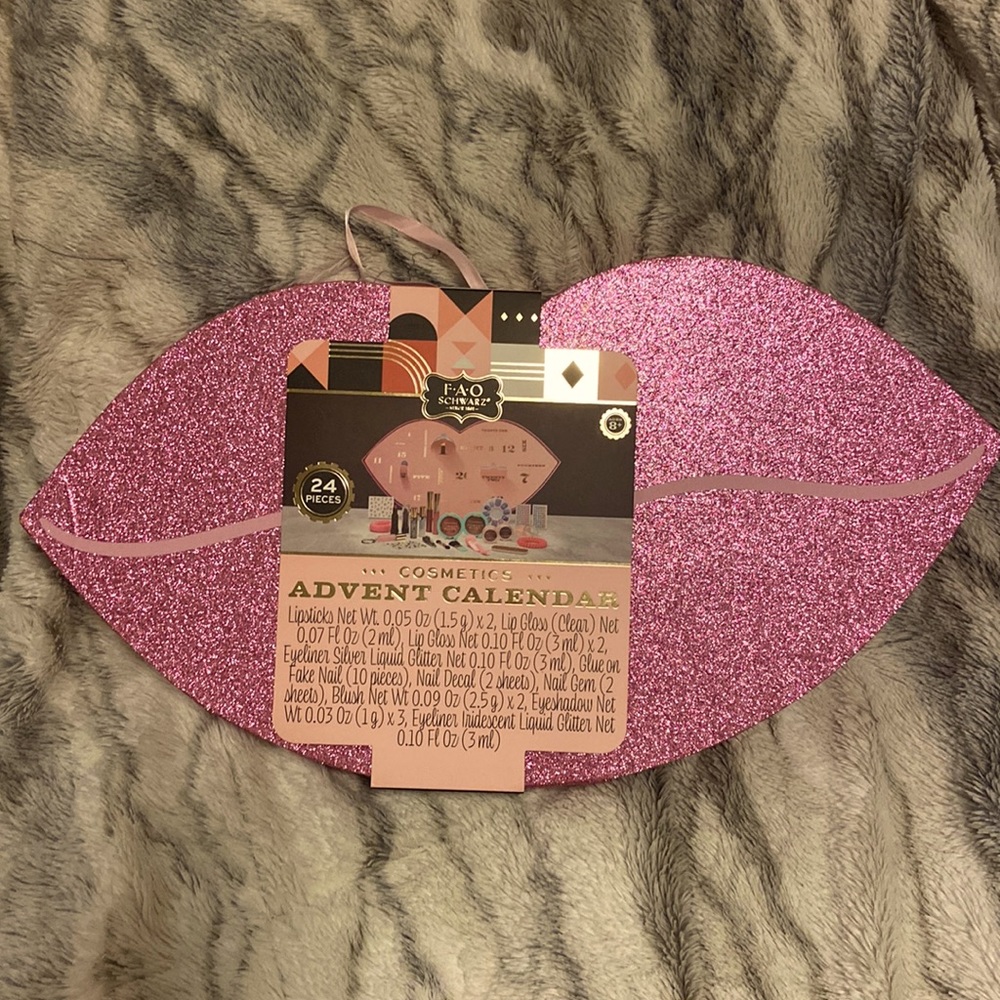 A 24 piece makeup and accessories kit for girls in a cute large lip shaped box